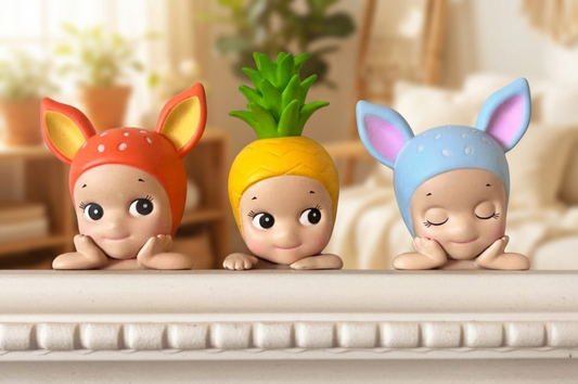 Close-up of Sonny Angel Hippers figures resting on a shelf, showcasing deer, pineapple, and mouse characters with soft pastel colors from the sonny angel hippers lineup.